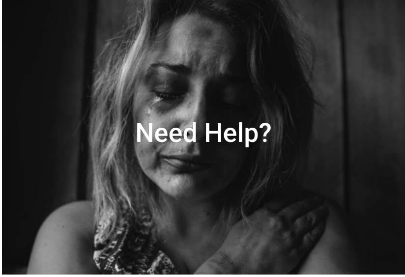 Distressed woman with bruised face, hand on chest, “Need Help?” text overlay